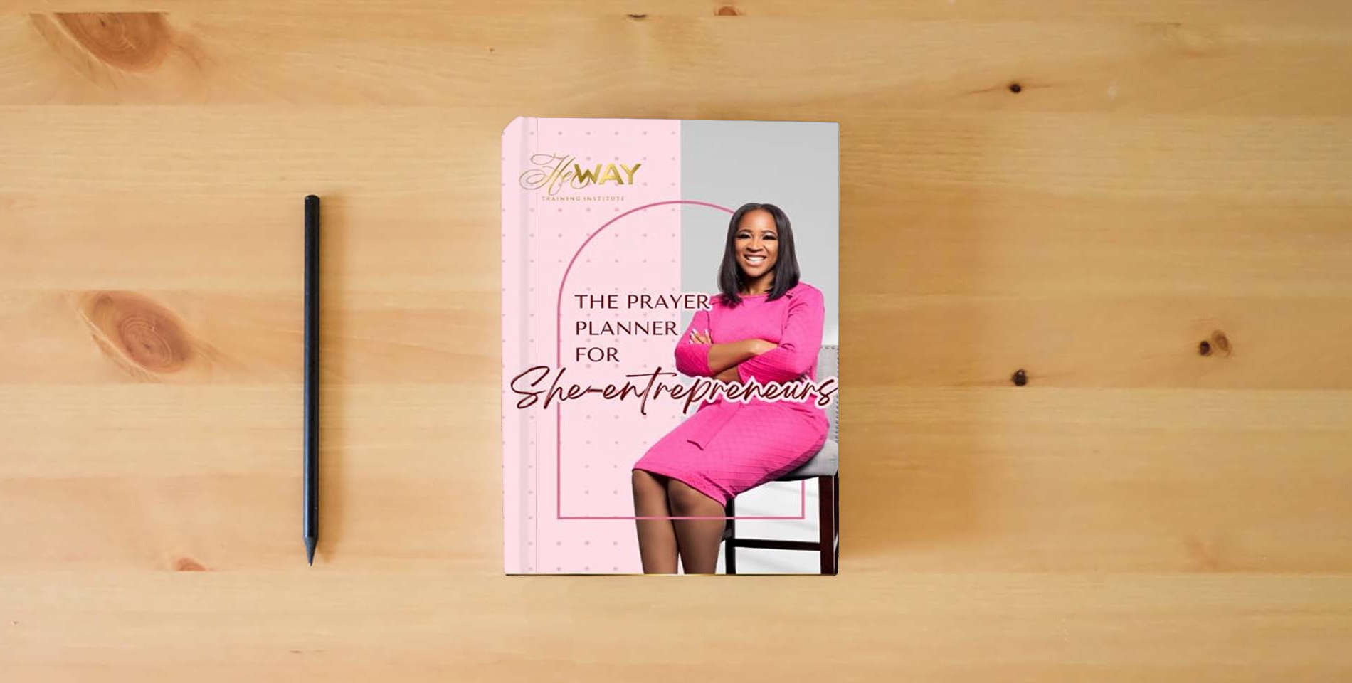 The book The Prayer Planner for She-Entrepreneurs: Manifesting Dreams Through Faith and Action is on the table