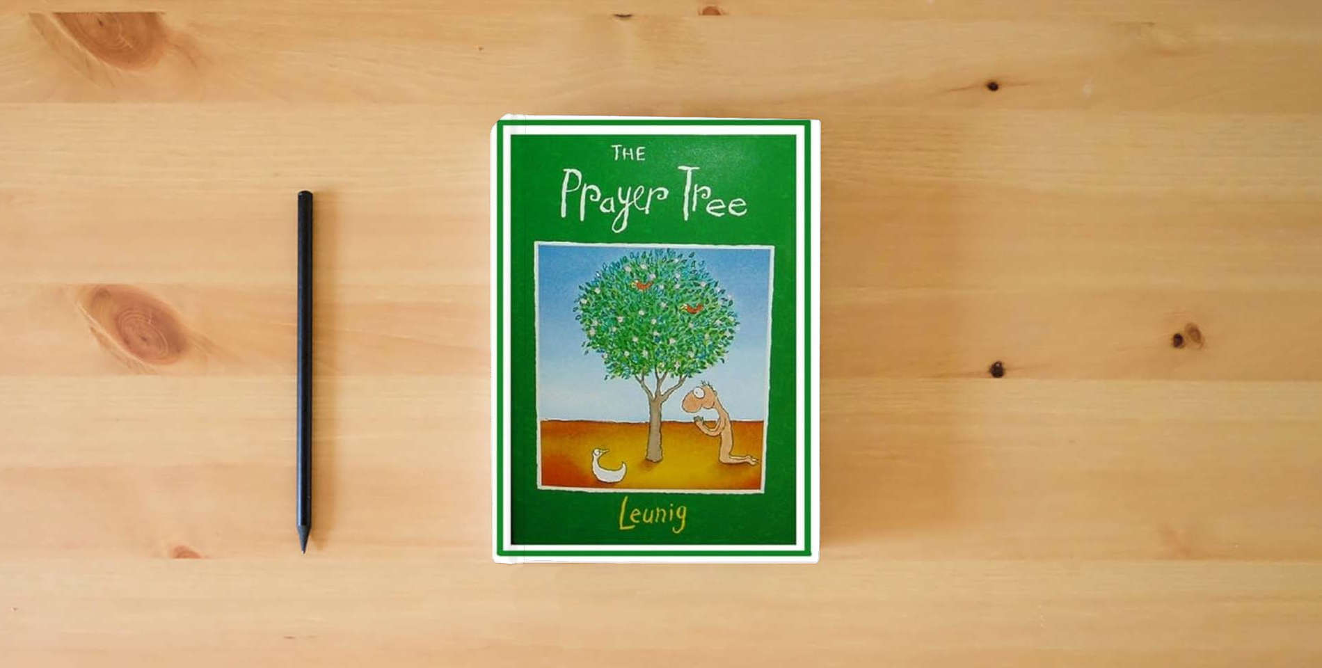 The book The Prayer Tree is on the table