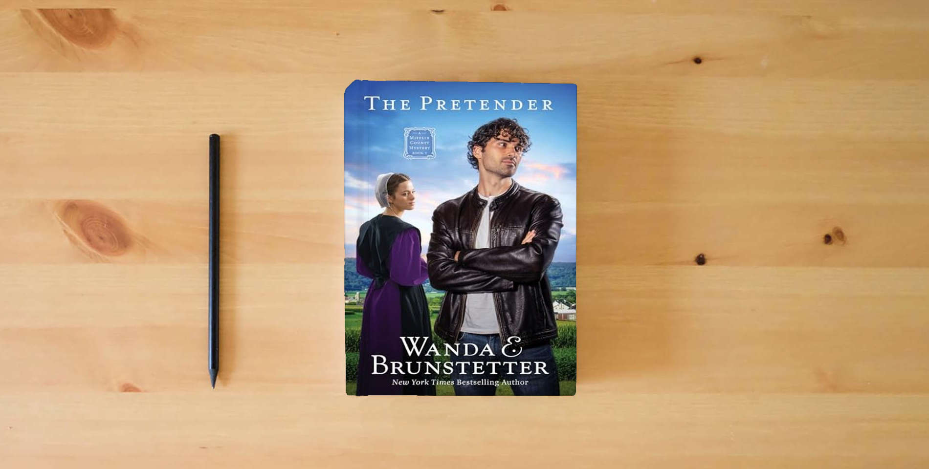 The book The Pretender: The Big Valley Disappearance #3 Volume 3 (A Mifflin County Mystery) is on the table