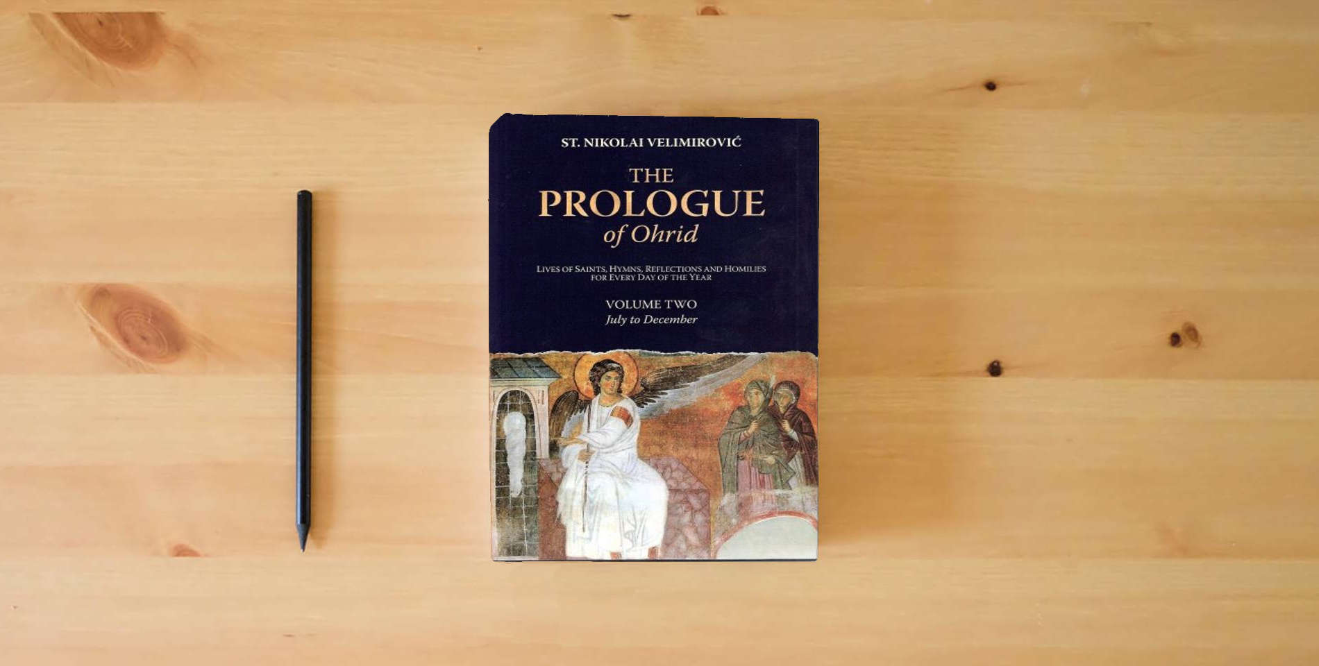 The book The Prologue of Ohrid: Lives of Saints, Hymns, Reflections and Homilies for Every Day of the Year (Volume 2: July to December) is on the table