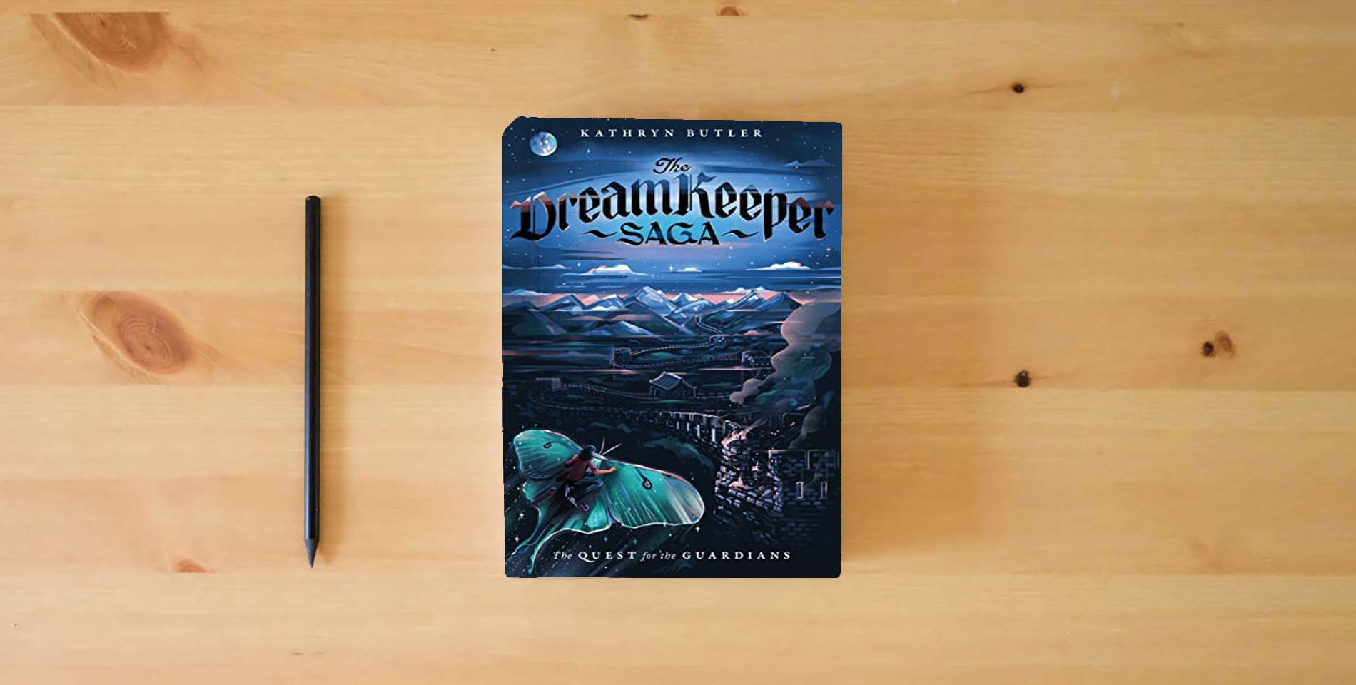 The book The Quest for the Guardians (The Dream Keeper Saga Book 4), Volume 4 is on the table