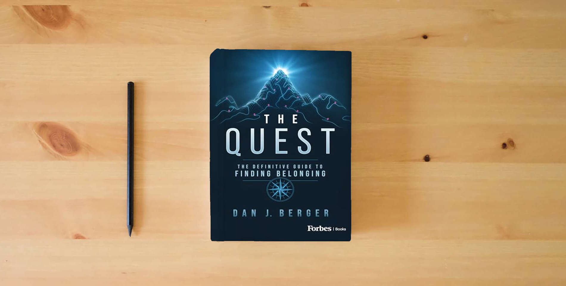 The book The Quest: The Definitive Guide to Finding Belonging is on the table