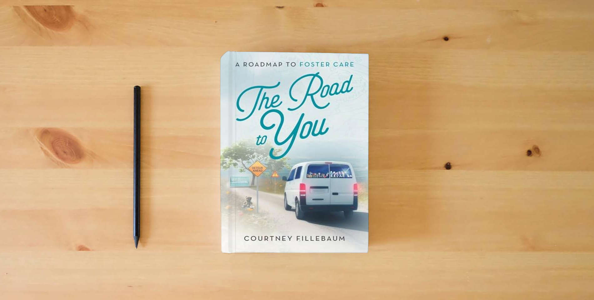 The book The Road to You: A Roadmap to Foster Care is on the table