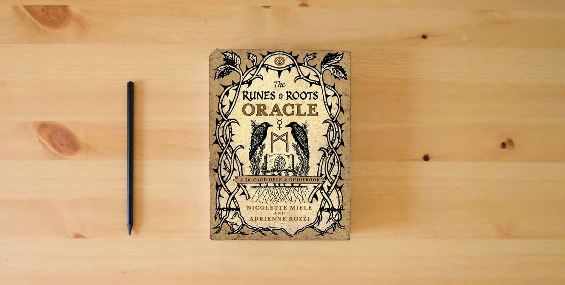The book The Runes and Roots Oracle: A 36-Card Deck and Guidebook is on the table