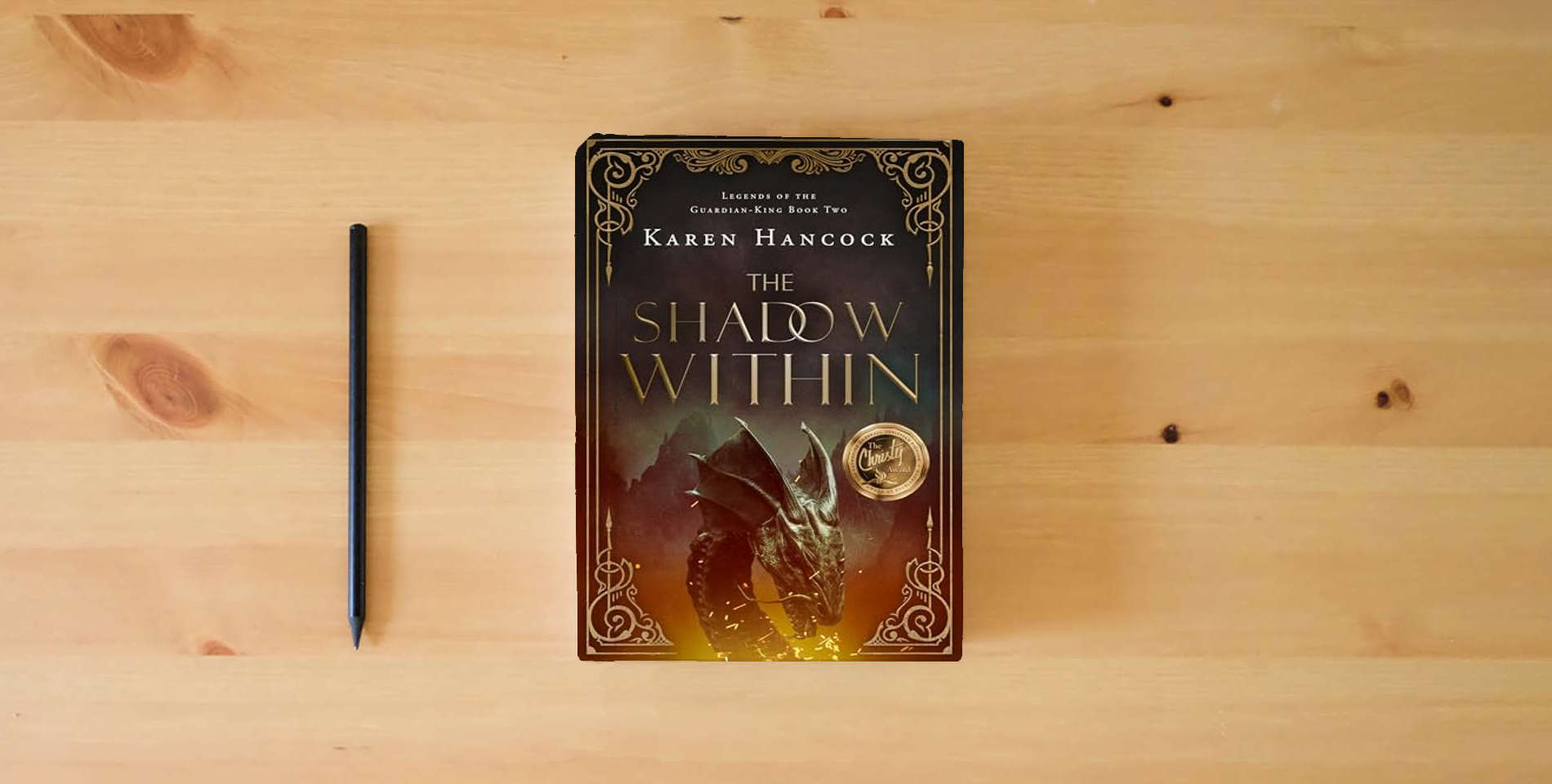 The book The Shadow Within (Volume 2) (Legends of the Guardian-King) is on the table