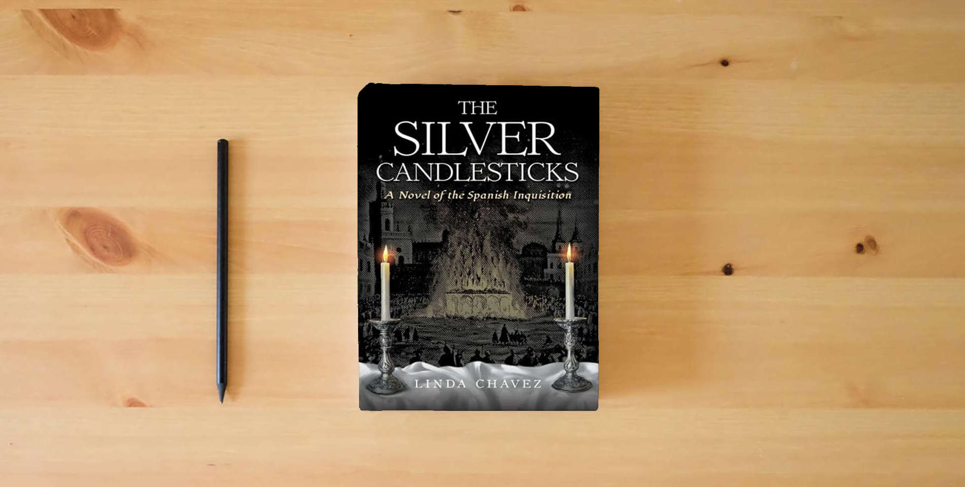 The book The Silver Candlesticks: A Novel of the Spanish Inquisition is on the table