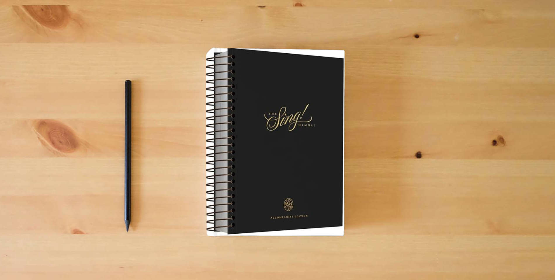 The book The Sing! Hymnal, Accompanist Edition is on the table