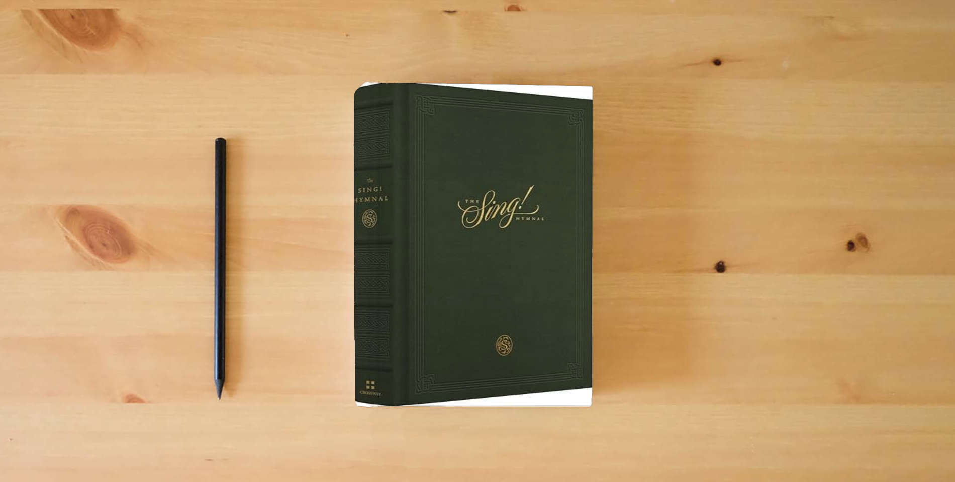 The book The Sing! Hymnal (Cloth over Board, Green) is on the table