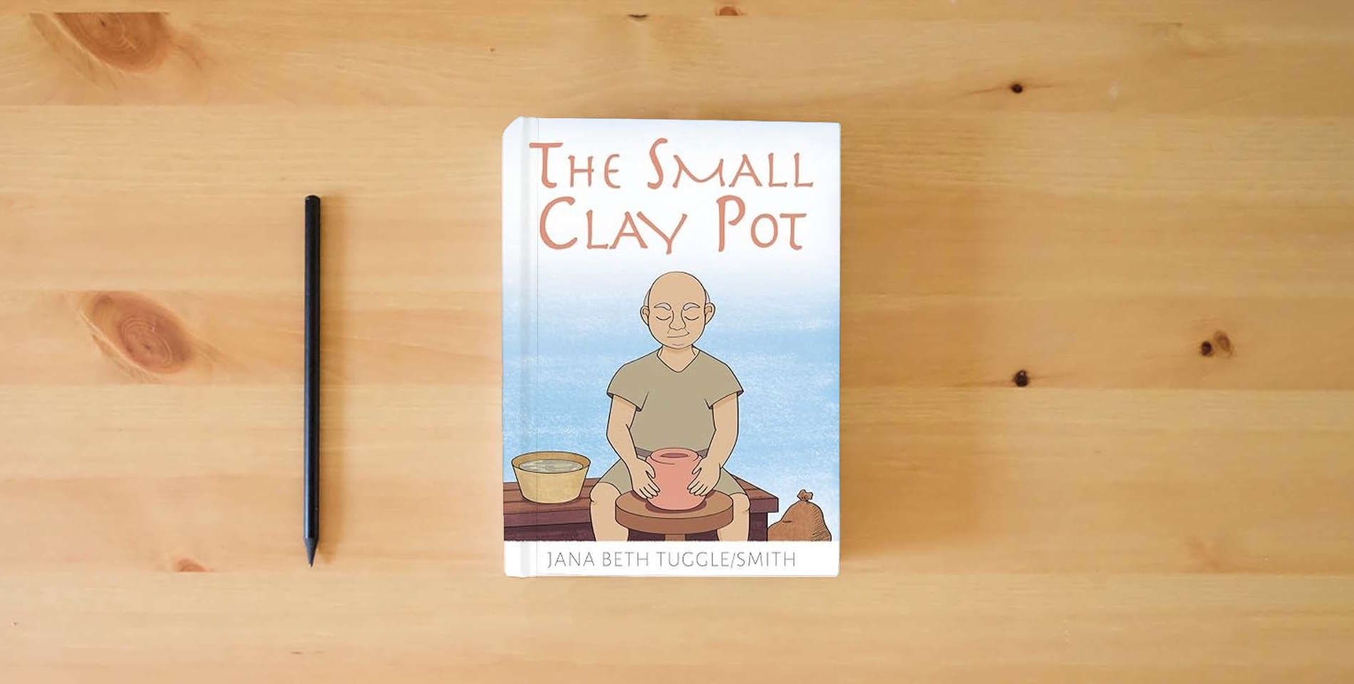 The book The Small Clay Pot is on the table