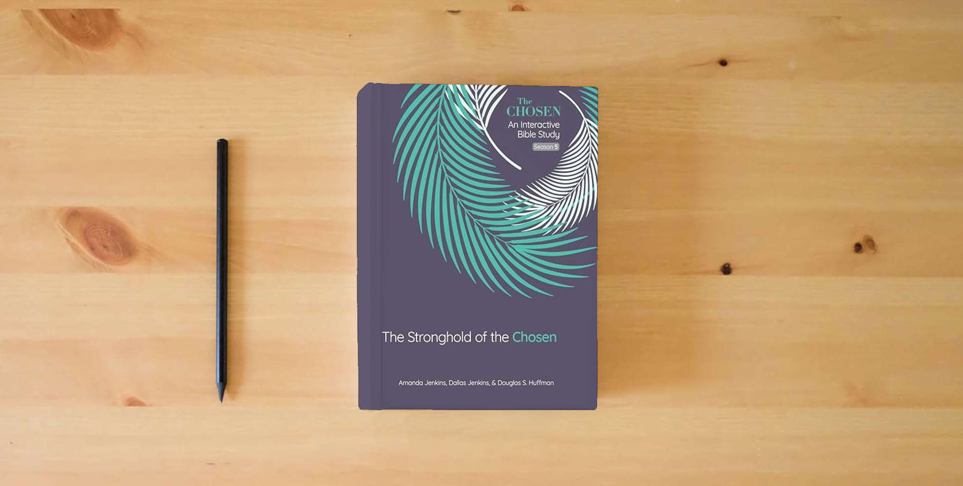 The book The Stronghold of the Chosen: An Interactive Bible Study Season 5 (Volume 5) (The Chosen Bible Study Series) is on the table