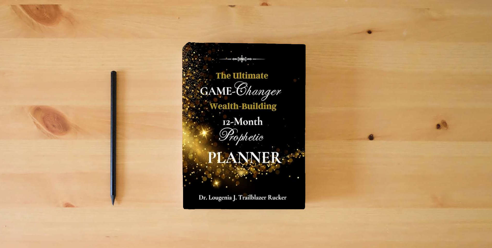 The book The Ultimate Game-Changer Wealth-Building 12-Month Prophetic Planner is on the table