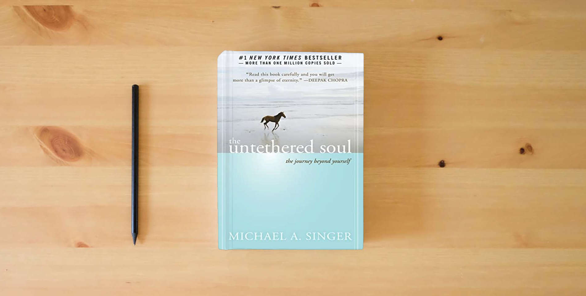 The book The Untethered Soul: The Journey Beyond Yourself is on the table