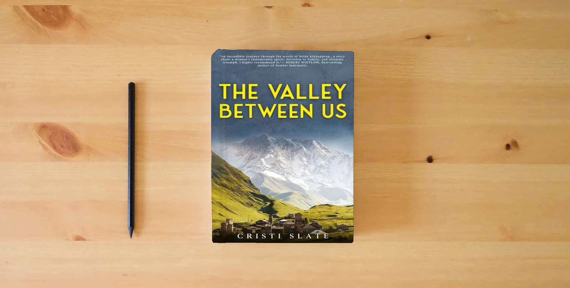 The book The Valley Between Us is on the table