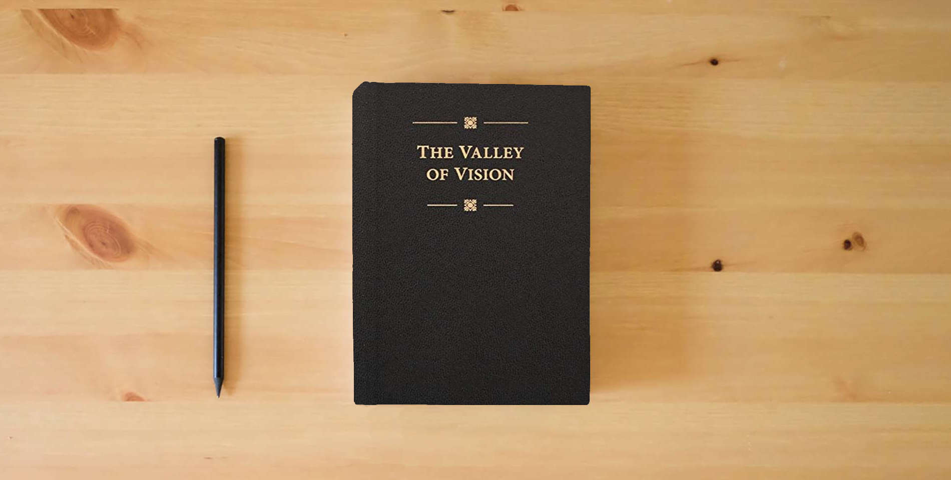 The book The Valley of Vision: A Collection of Puritan Prayers & Devotions is on the table