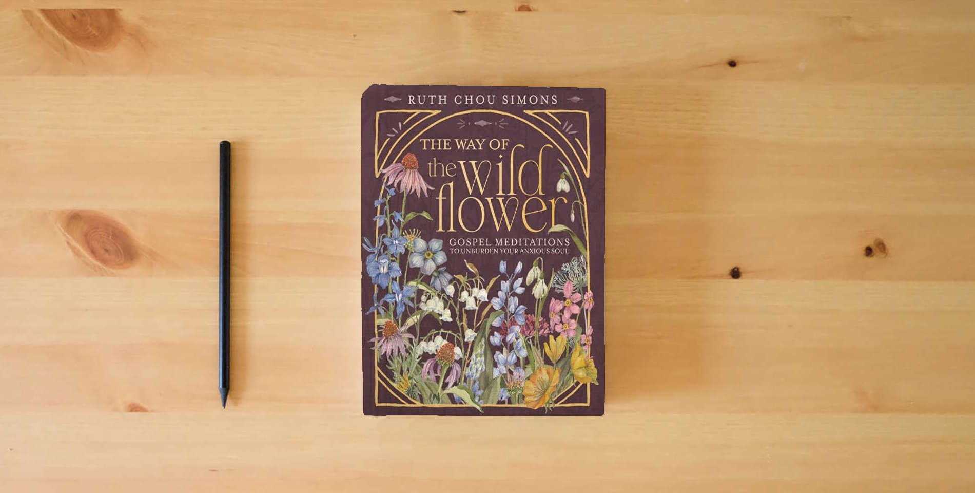 The book The Way of the Wildflower: Gospel Meditations to Unburden Your Anxious Soul is on the table