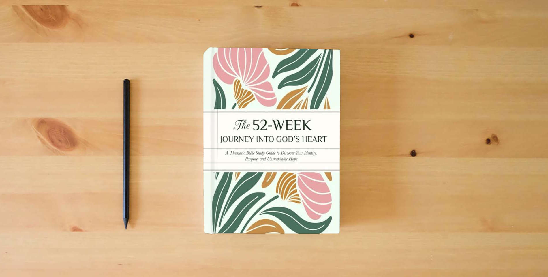 The book The 52-Week Journey into God’s Heart: A Thematic Bible Study Guide to Discover Your Identity, Purpose, and Unshakeable Hope author is on the table