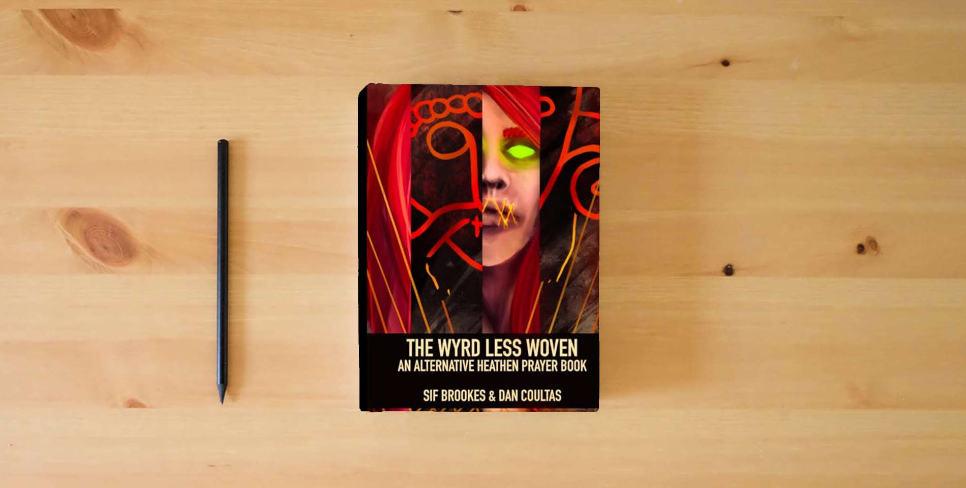 The book The Wyrd Less Woven: An Alternative Heathen Prayer Book is on the table