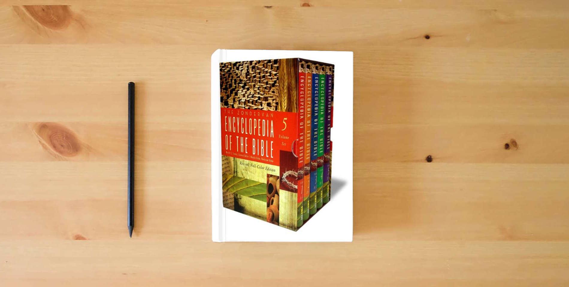 The book The Zondervan Encyclopedia of the Bible: Revised Full-Color Edition is on the table
