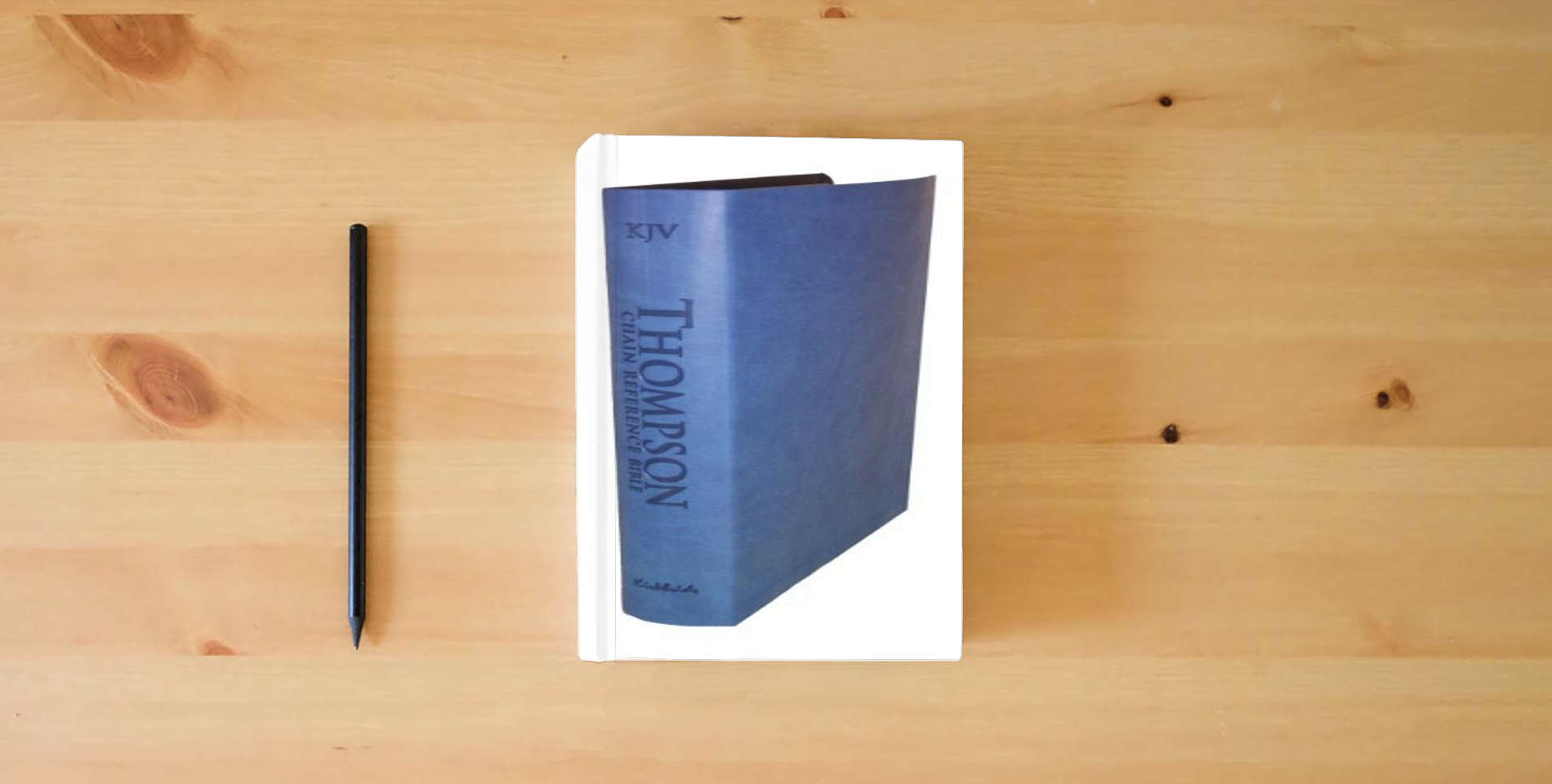 The book Thompson Chain Reference Bible (Style 507blue) - Regular Size KJV - Deluxe Kirvella is on the table