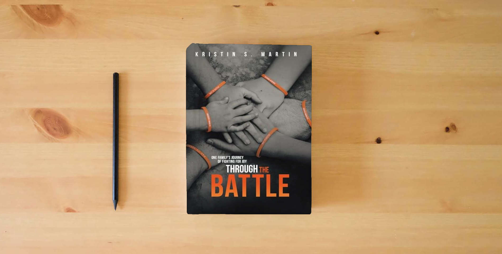 The book Through the Battle: One Family's Journey of Fighting for Joy is on the table
