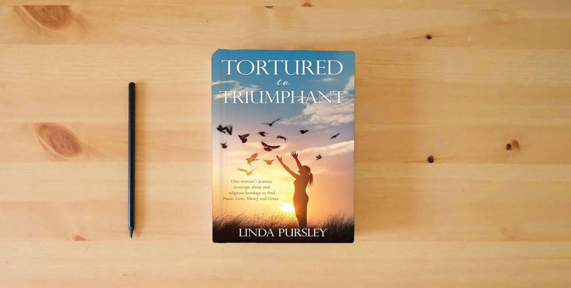 The book Tortured to Triumphant is on the table