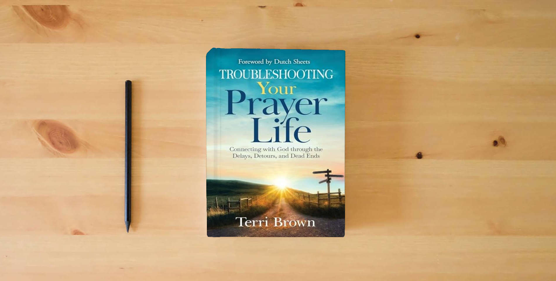 The book Troubleshooting Your Prayer Life: Connecting with God through the Delays, Detours, and Dead Ends is on the table