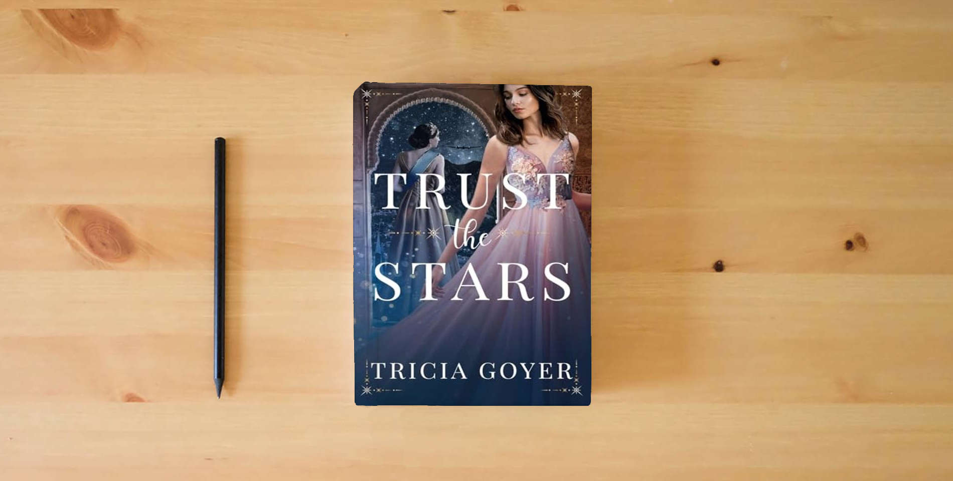 The book Trust the Stars is on the table