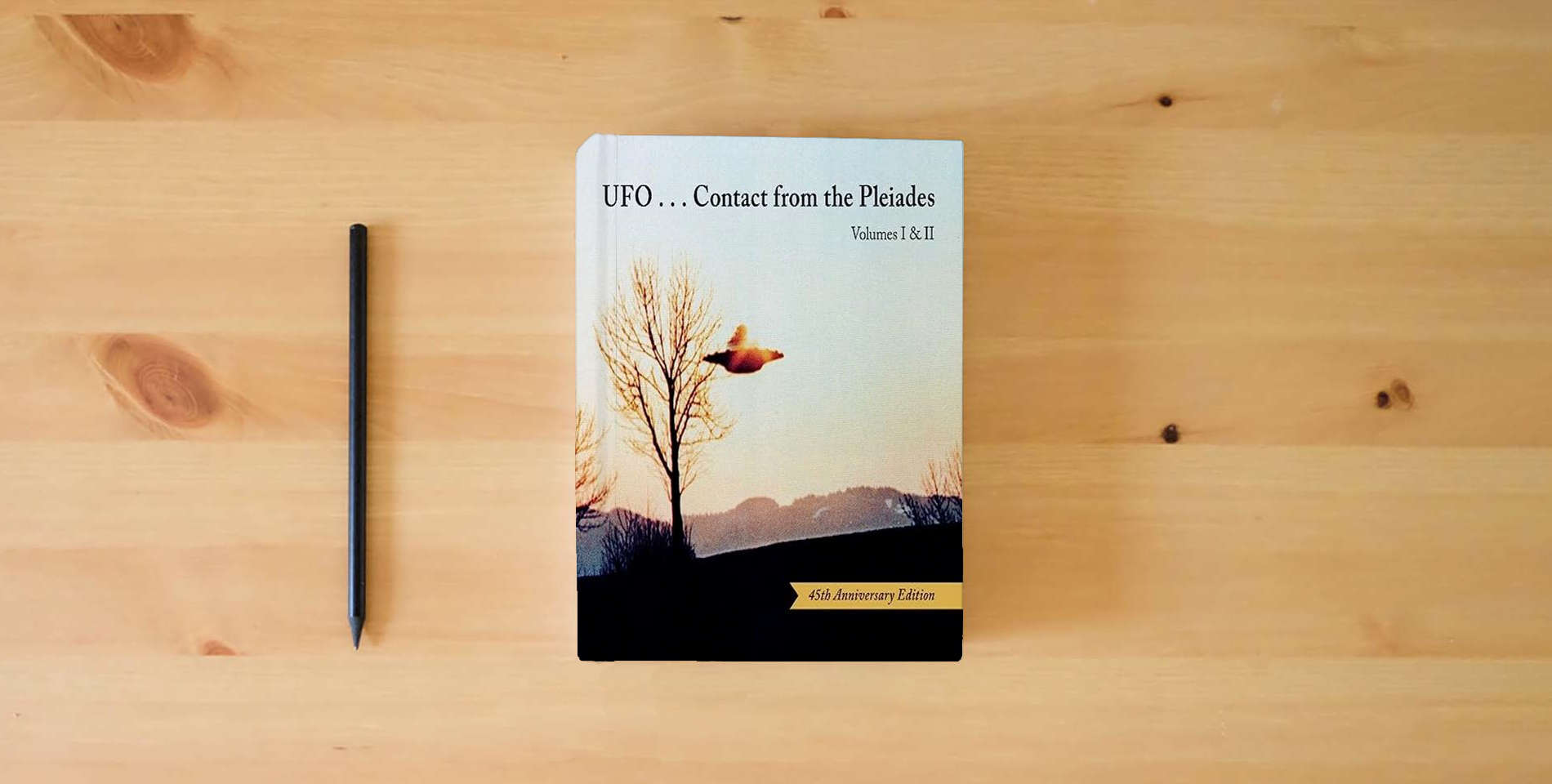 The book UFO...Contact from the Pleiades (45th Anniversary Edition) is on the table