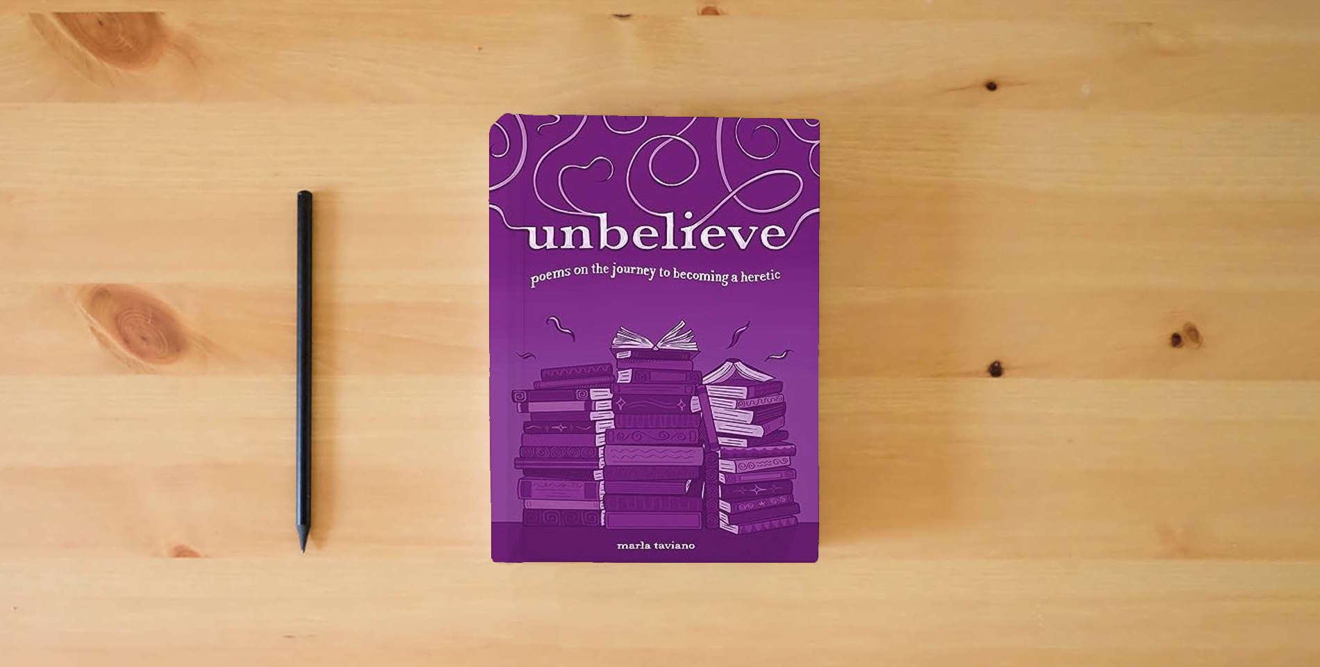 The book unbelieve: poems on the journey to becoming a heretic is on the table