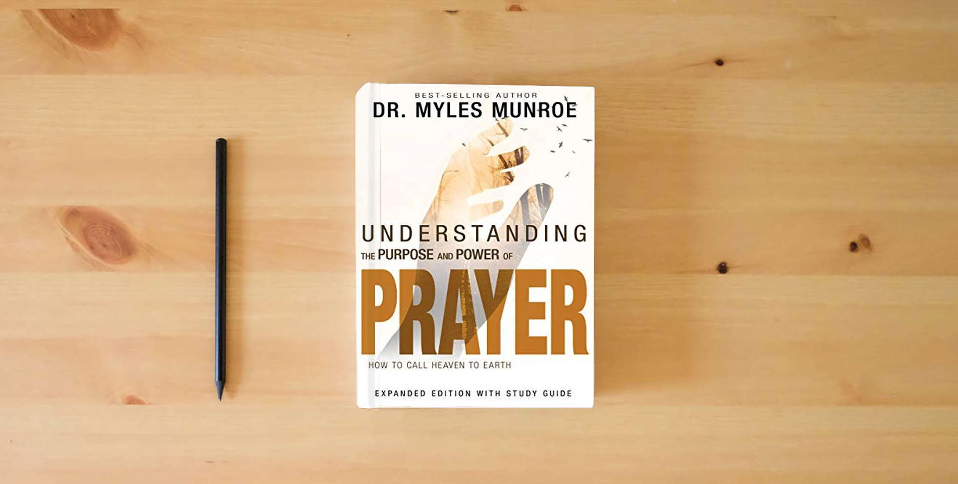 The book Understanding the Purpose and Power of Prayer: How to Call Heaven to Earth is on the table