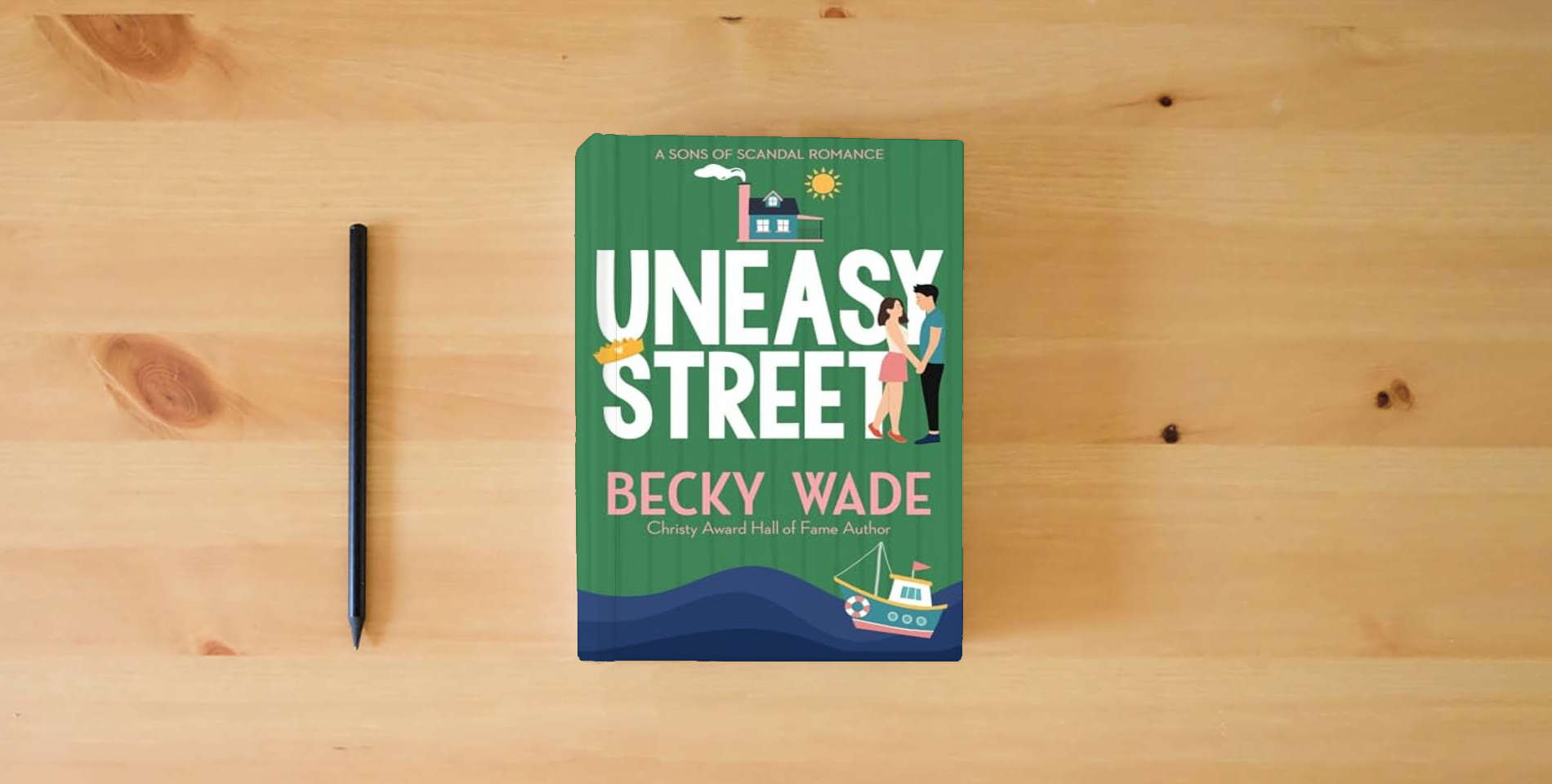 The book Uneasy Street: A Sweet "Enemies to Lovers" Romance (Sons of Scandal) is on the table