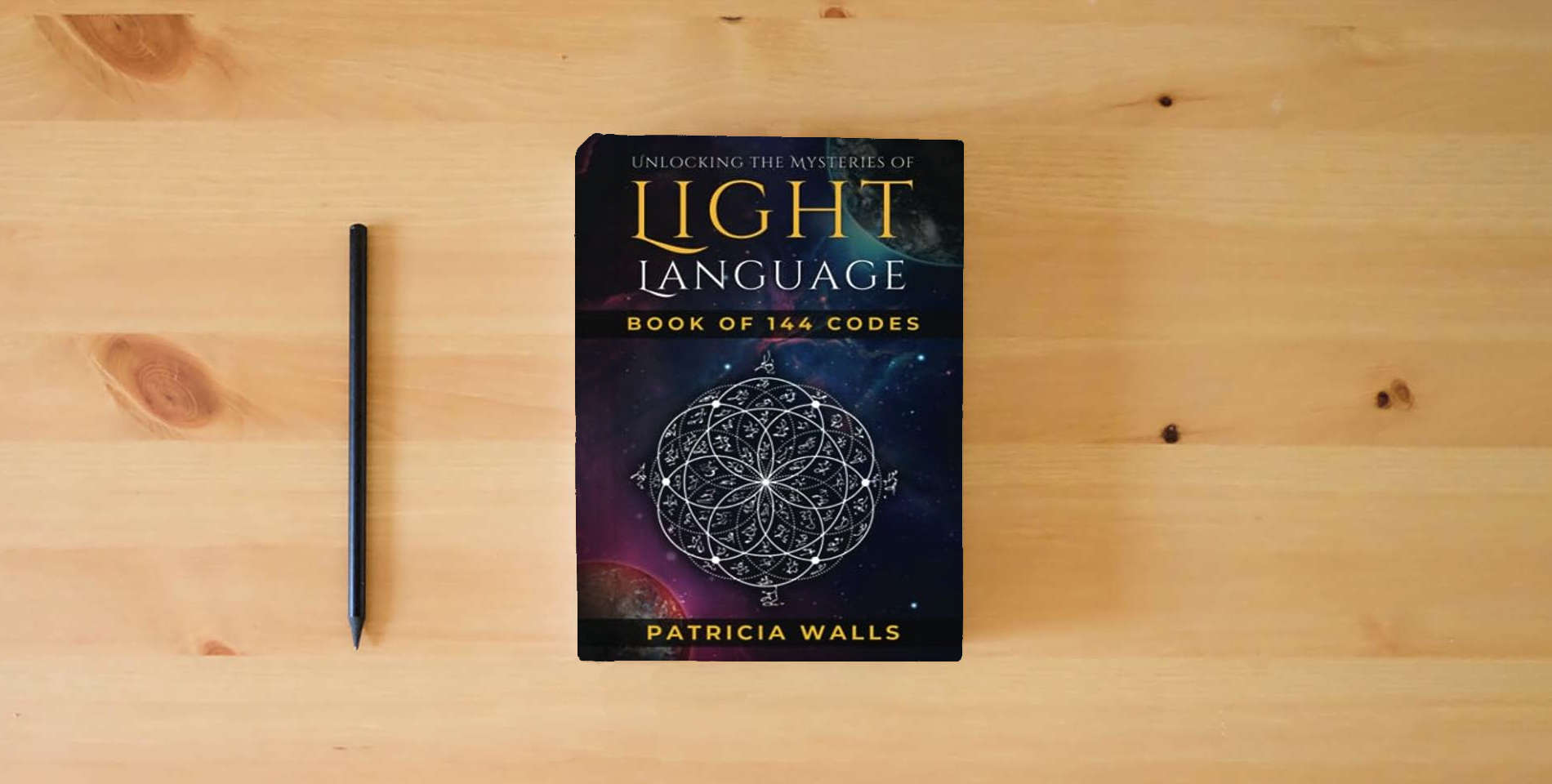 The book Unlocking The Mysteries of Light Language: Book of 144 Codes is on the table