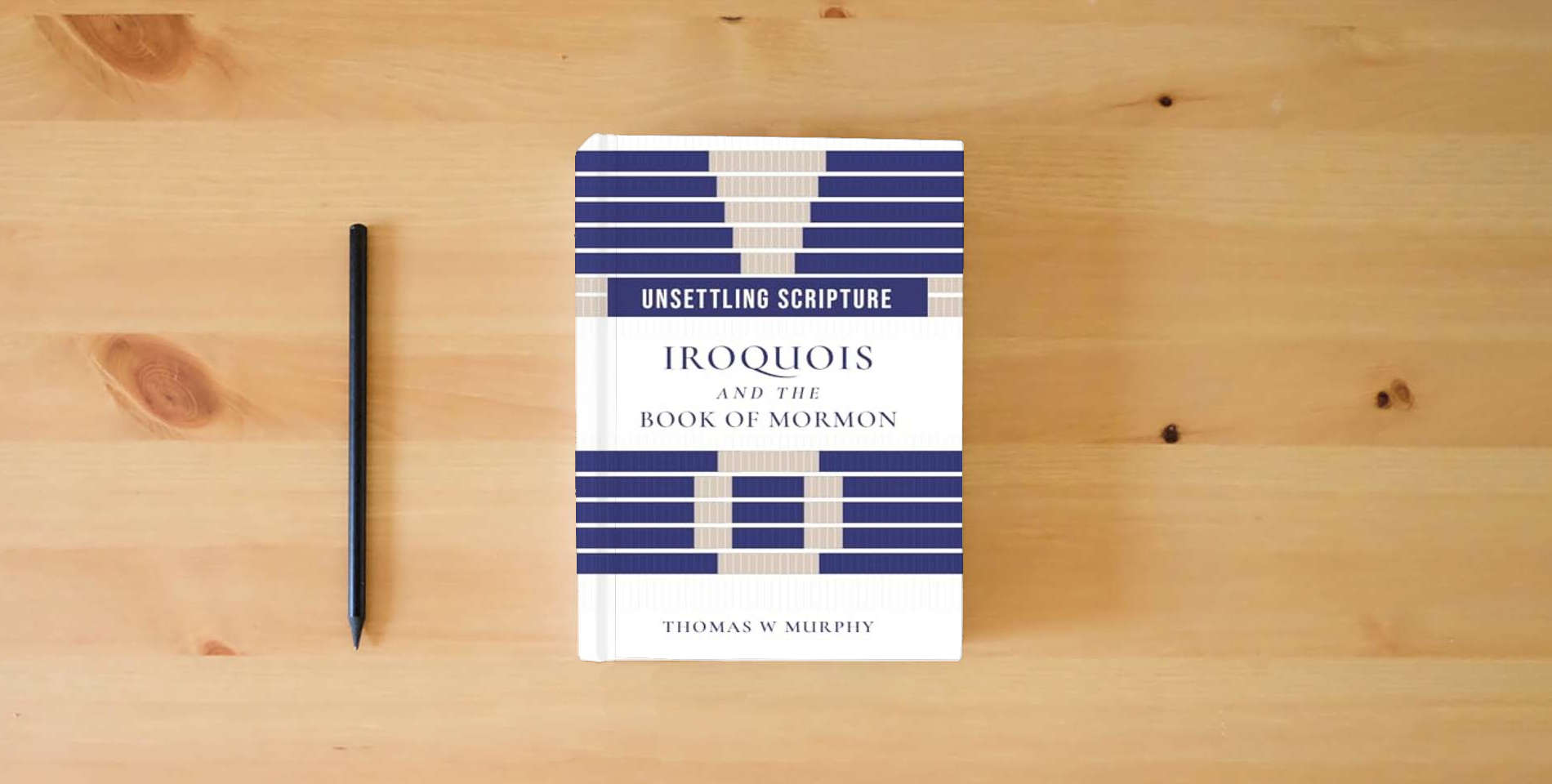 The book Unsettling Scripture: Iroquois and the Book of Mormon (Juanita Brooks Series in Mormon History and Culture) is on the table