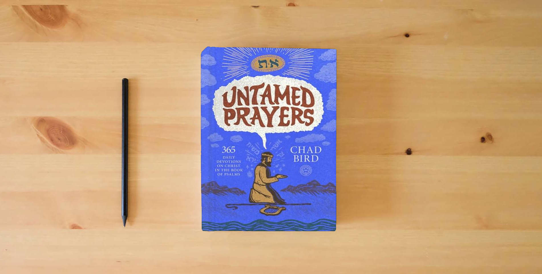 The book Untamed Prayers: 365 Daily Devotions on Christ in the Book of Psalms is on the table