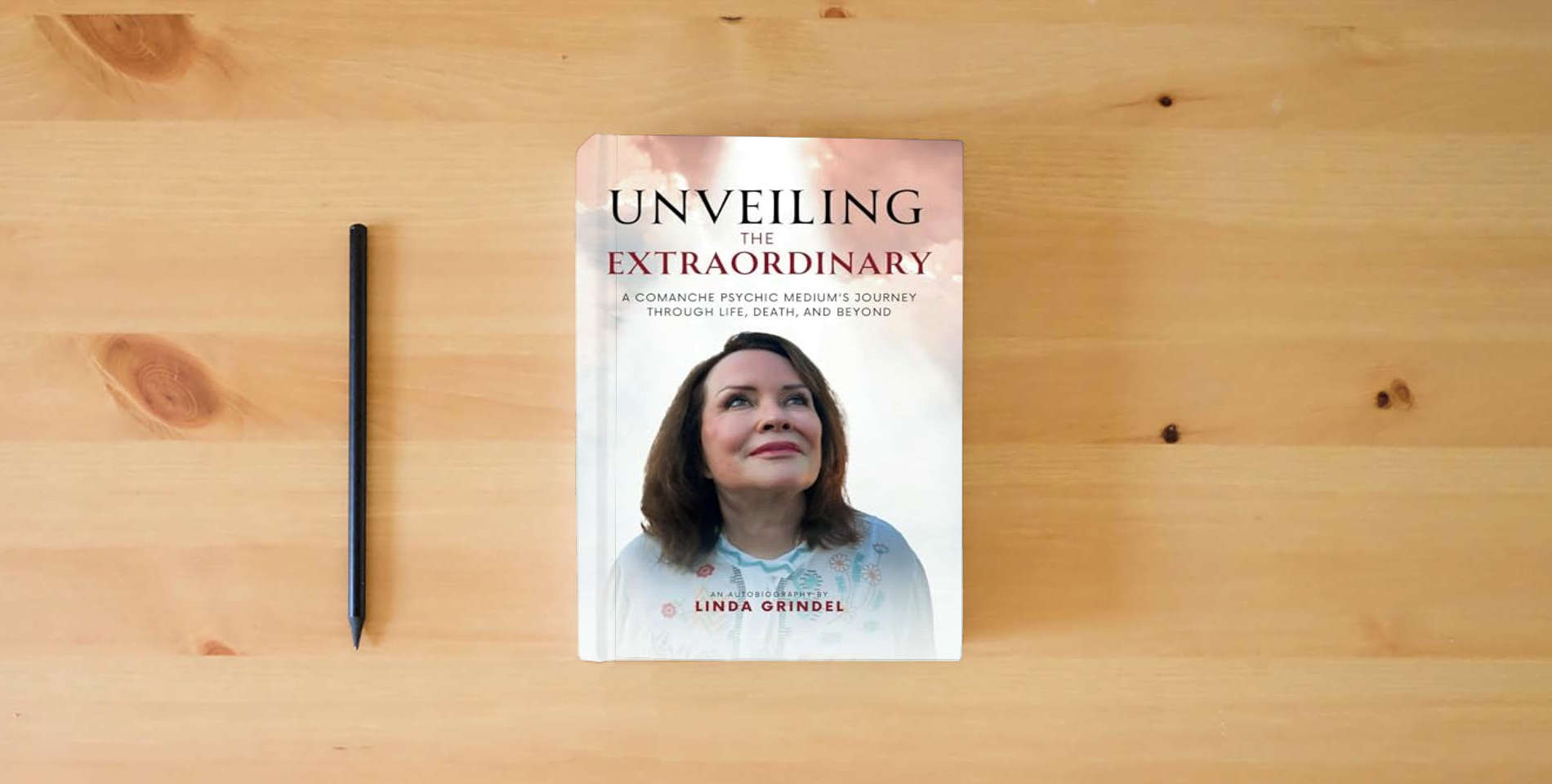 The book Unveiling the Extraordinary: A Comanche Psychic Medium's Journey Through Life, Death, and Beyond is on the table