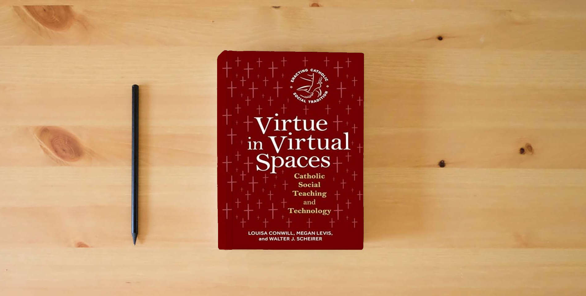 The book Virtue in Virtual Spaces: Catholic Social Teaching and Technology (Enacting Catholic Social Tradition) is on the table