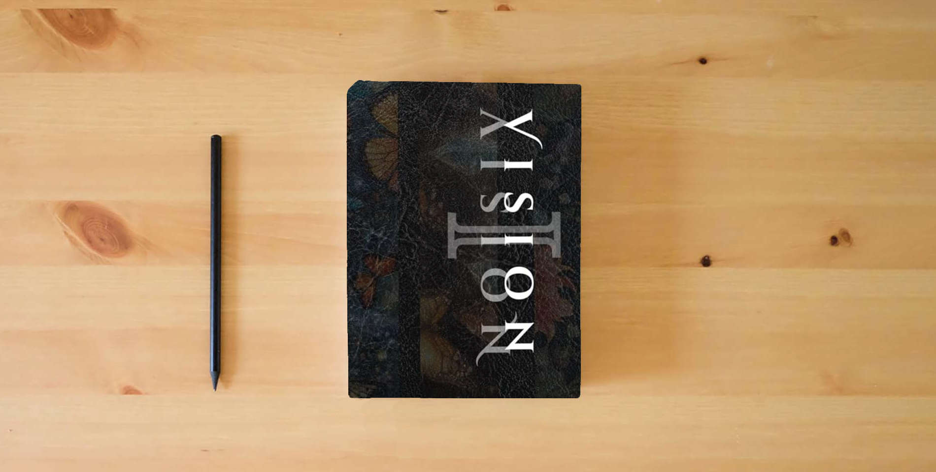 The book Vision 1: Your magick coloring book, spell guide & journal is on the table