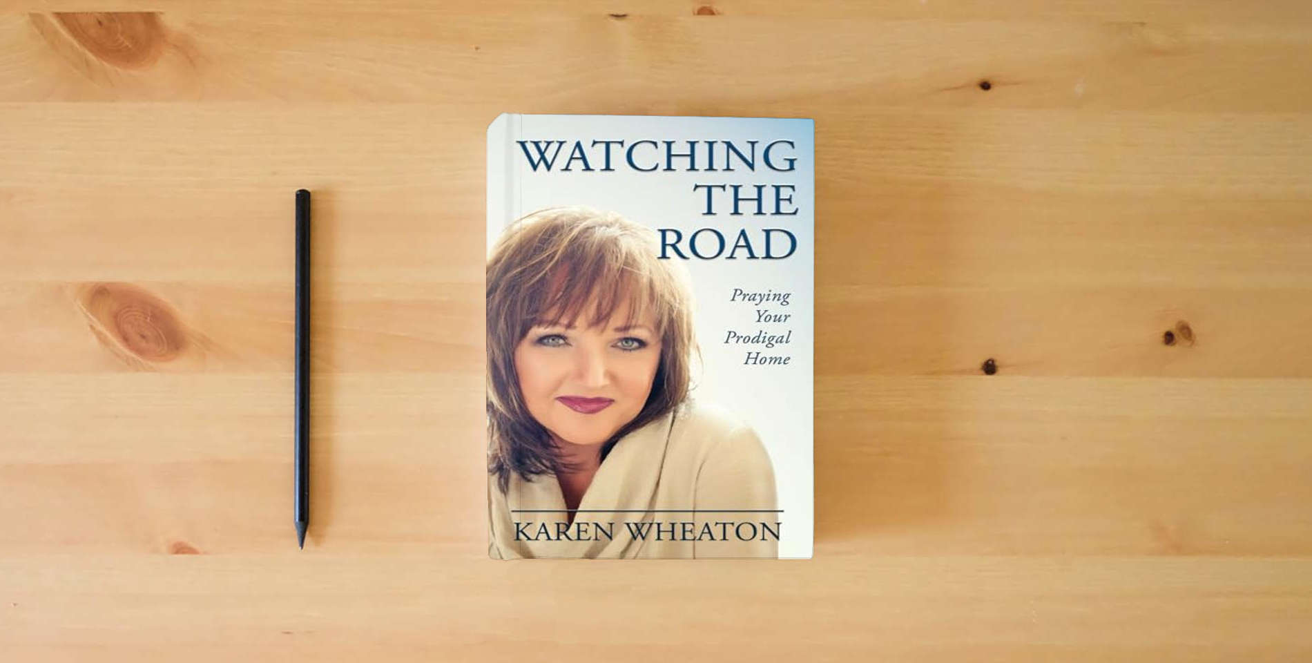 The book Watching The Road: Praying Your Prodigal Home is on the table
