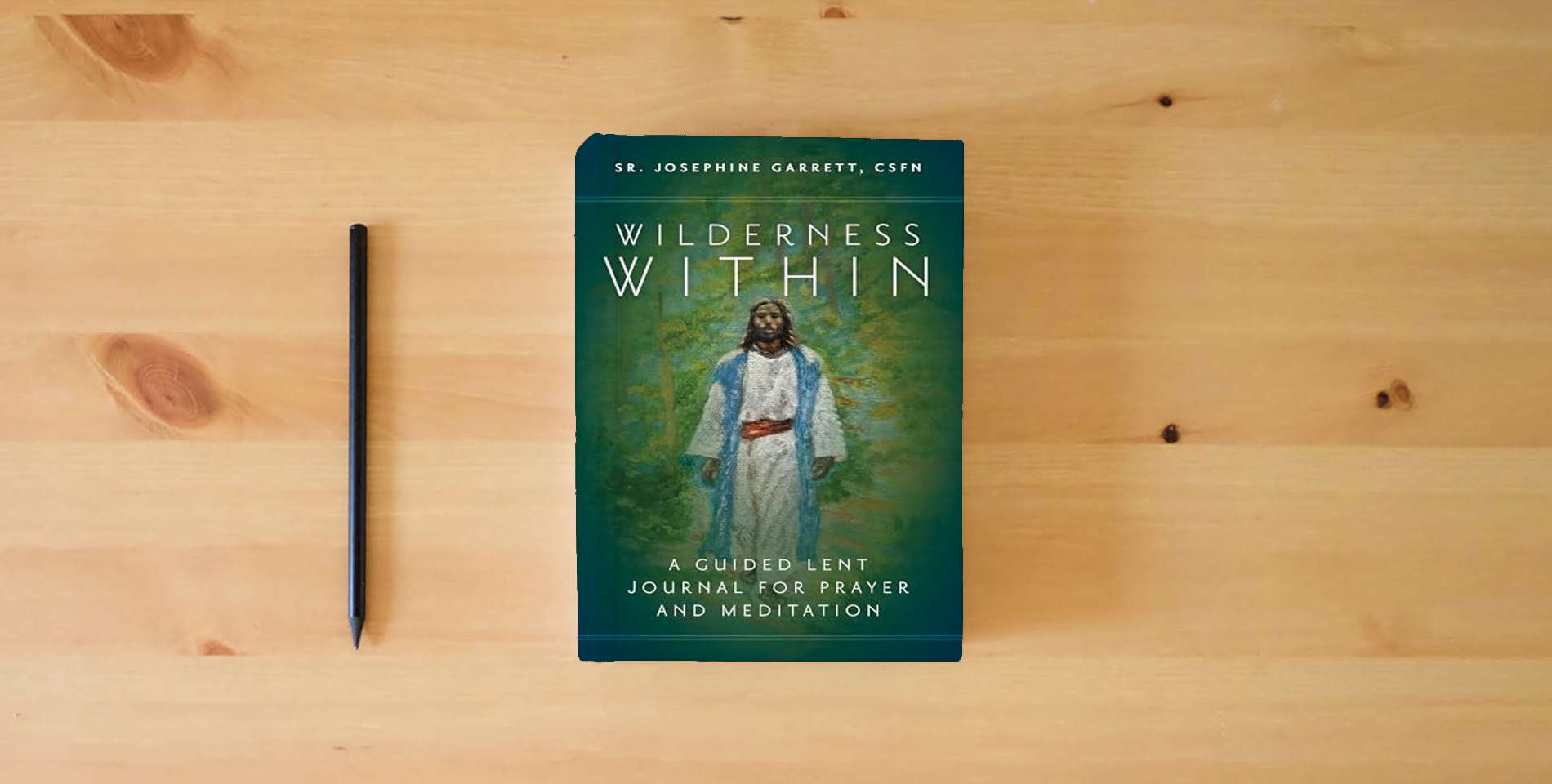 The book Wilderness Within: A Guided Lent Journal for Prayer and Meditation is on the table
