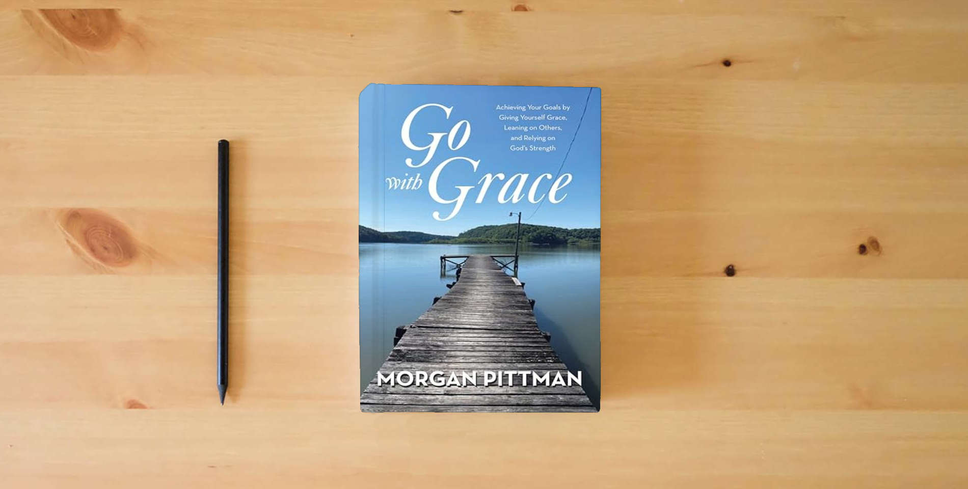 The book Go with Grace: Achieving Your Goals by Giving Yourself Grace, Leaning on Others, and Relying on God's Strength is on the table