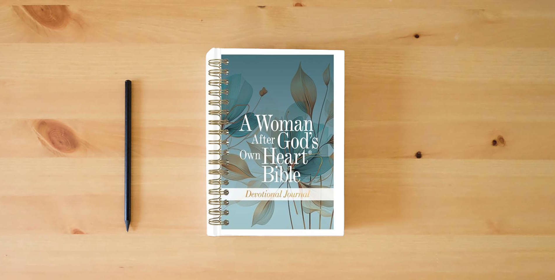 The book A Woman After God's Own Heart Bible Devotional Journal is on the table
