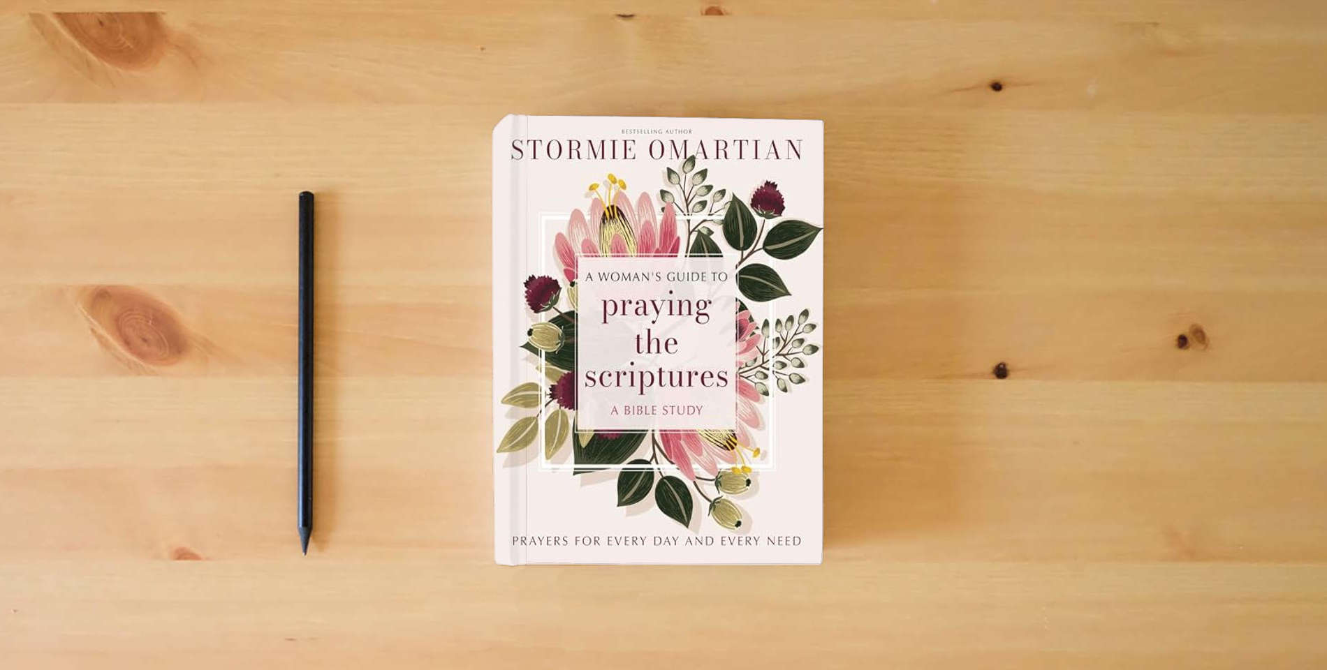 The book A Woman's Guide to Praying the Scriptures: Prayers for Every Day and Every Need is on the table