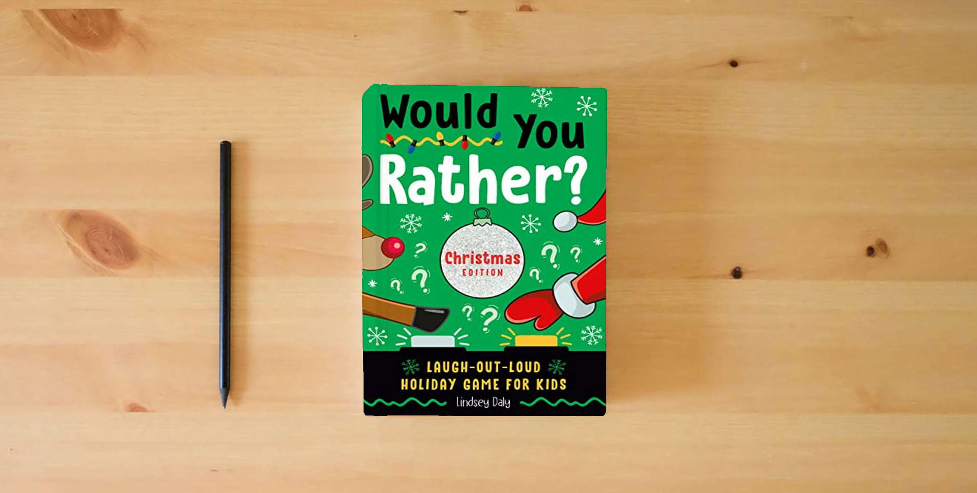 The book Would You Rather? Christmas Edition: Laugh-Out-Loud Holiday Game for Kids is on the table