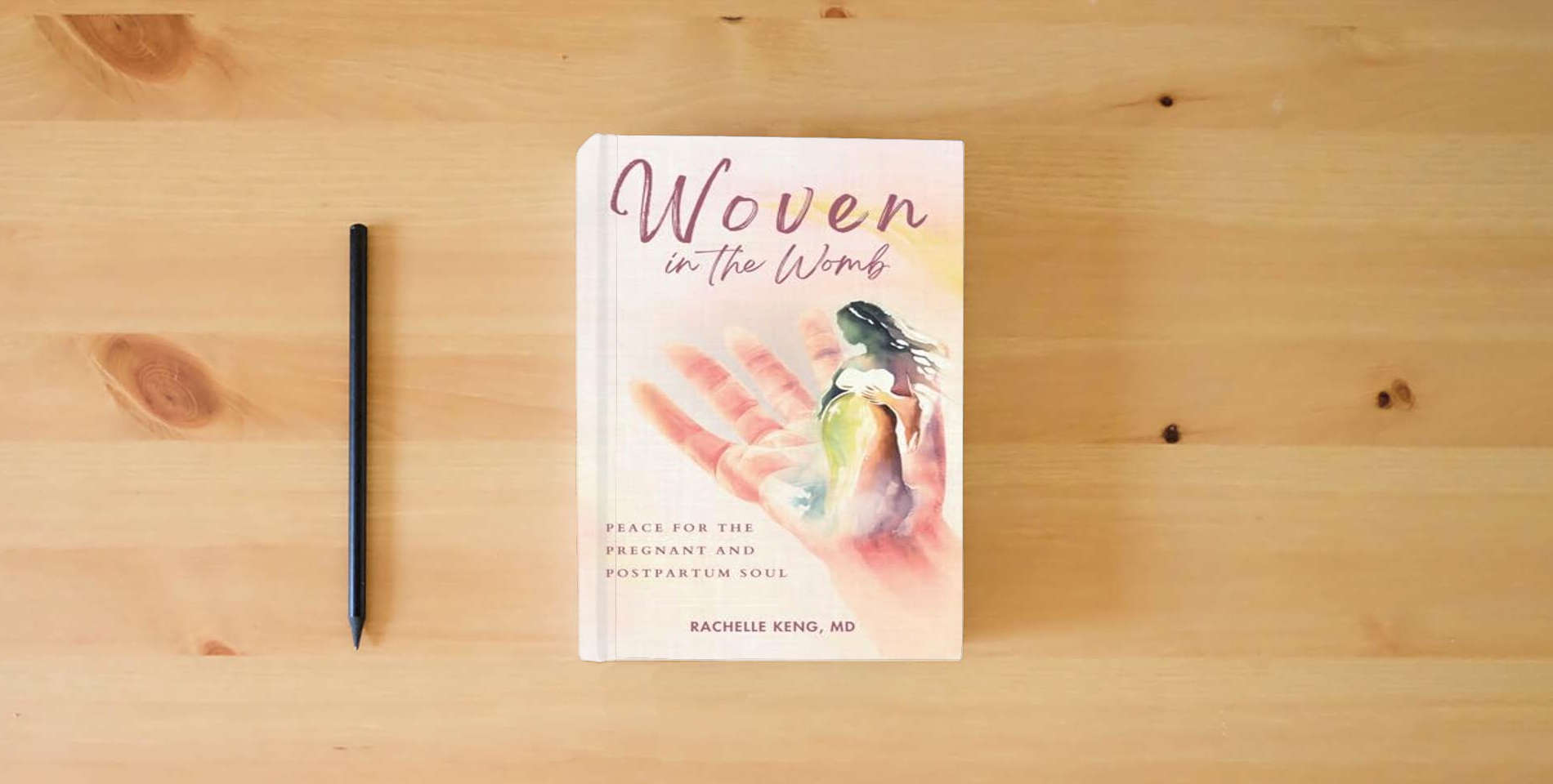 The book Woven in the Womb: Peace for the Pregnant and Postpartum Soul is on the table