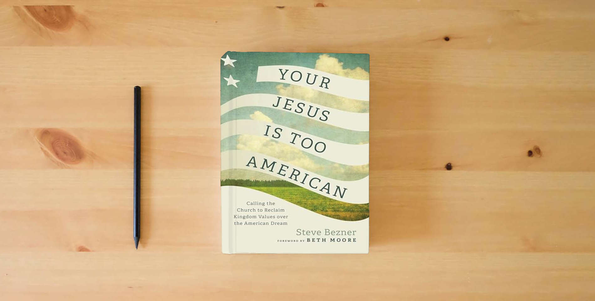 The book Your Jesus Is Too American: Calling the Church to Reclaim Kingdom Values over the American Dream is on the table