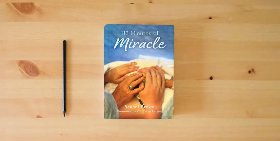 The book 112 Minutes of Miracle} is on the table