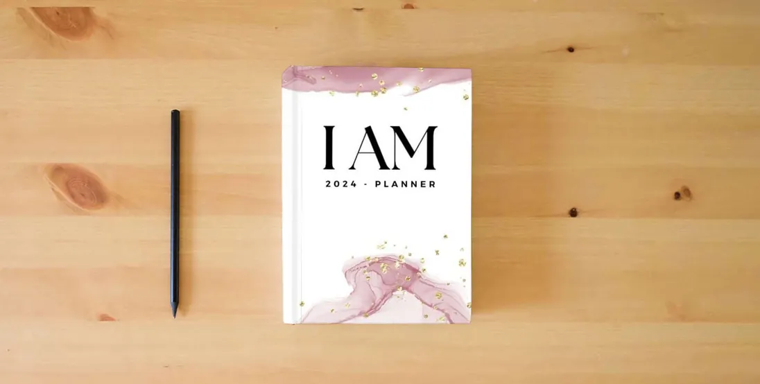 The book 2024 - I AM PLANNER - Weekly & Monthly Planner, Manifest Journal, Affirmations, Vision Board, Habits, Goals, Mantras, Reflection Sheets, Rituals, ... I live my most Badass and Beautiful Life!} is on the table