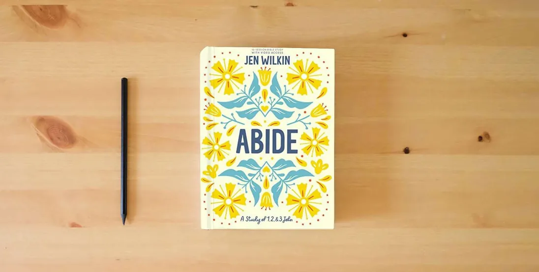 The book Abide - Bible Study Book with Video Access: A Study of 1, 2, and 3 John} is on the table