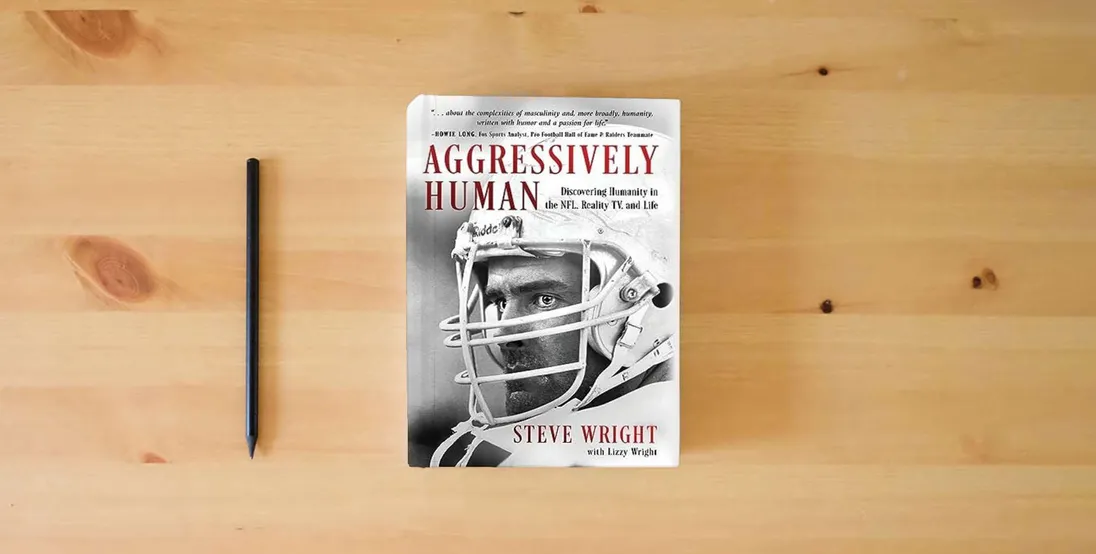The book Aggressively Human: Discovering Humanity in the NFL, Reality TV, and Life} is on the table