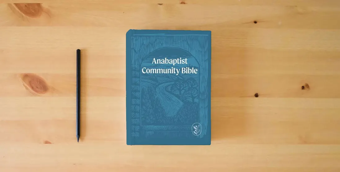 The book Anabaptist Community Bible: Soft Touch Edition} is on the table